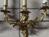 three candles that are on the wall in the room