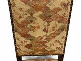 an upholstered upholstered chair with a floral pattern on the back