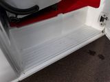 a white truck with a red door and a hose attached to it