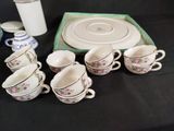 many cups and saucers sitting on a table