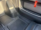 the interior of a car with the door open and the seat down