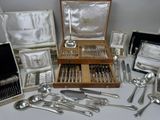 a lot of silverware in a case on a table