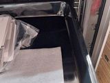 a stack of papers sitting in the open oven door