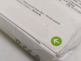 a white box with a green arrow on top of it