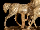 a statue of a horse and a foal that are standing together