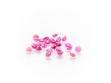 a pile of pink glass beads on a white surface