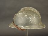 a helmet on a stand with a rope around it