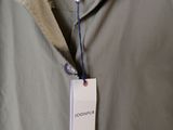 an image of a jacket hanging on a hanger in a store