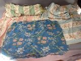 a bed that has a bunch of different types of clothes on it