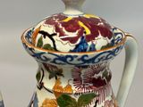 a close up of a vase with a lid on it