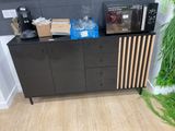 a black cabinet with a bunch of items on top of it