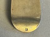 a silver spoon that is sitting on a table