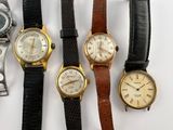 several different types of watches are lined up on a white surface