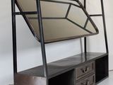 a metal shelf with a mirror on top of it