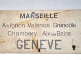 a sign that says marseille on it on a white wall