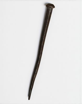 a close up of a small metal object on a white surface