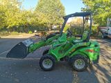 a green tractor that is parked in the parking lot