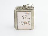 a small metal box with a picture of a bird on it