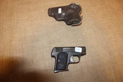 un pistolet et un étui posés par terre