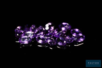 purple amethorate gems on a black background