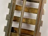 a small metal cage with two bars in it