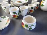 a lot of dishes and cups sitting on a table