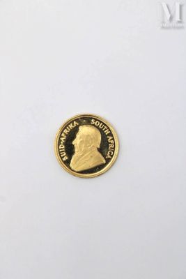 a close up of a gold coin on a white surface