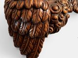 a wooden carving of an owl on a white background