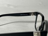 glasses with a black frame and a silver rim on a white surface