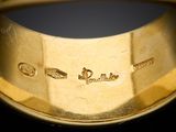 a close up of a gold ring with different symbols on it