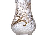 a clear glass vase with a gold design on it