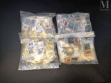four bags of assorted legos sitting on a table