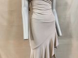 the mannequin is wearing a beige dress with ruffles on it