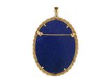 a close up of a blue stone pendant on a white background