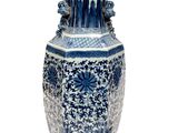 a blue and white vase with a floral design on it