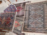 several rugs are laid out on the floor in a room