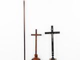 two crosses and a cross on a pedestal in a white room