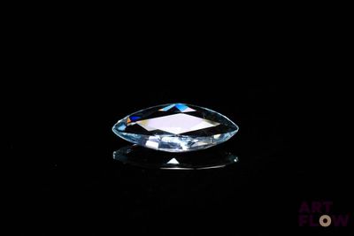 a close up of a faceted blue diamond on a black background