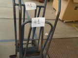 a pile of luggage sitting on the floor in a warehouse