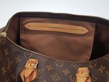 a close up of a brown louis vuitton bag