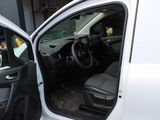 a white van with the door open and the driver ' s seat down
