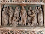 a statue of a group of people on a wall