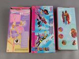 three boxes of barbie dolls are lined up on a table