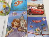 several disney pixal books and a dvd sitting on a table