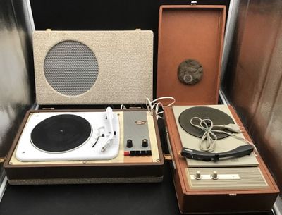 two turntables and a record player sitting on a table