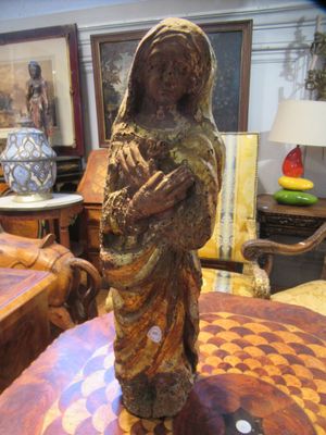 a statue of a woman holding a baby on a table