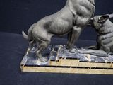 a statue of a dog and a dog sitting on a table