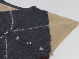 a sweater that is laying on a white table