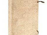 an old book with writing on it sitting on top of a white surface
