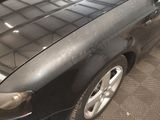 a black car that is parked in a parking lot